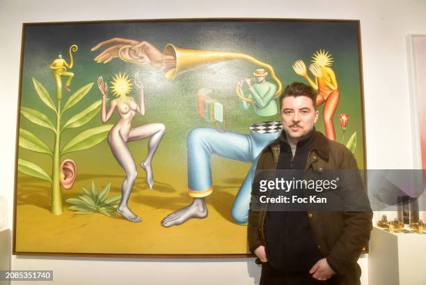 Painter Waone poses with his work during "Cyber Surrealisme" Group Preview at Goldshteyn Saatort Gallery on March 14, 2024 in Paris, France.
