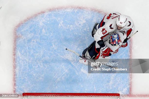 Tom Wilson and Charlie Lindgren of the Washington Capitals react after their 2-1 win against the Seattle Kraken at Climate Pledge Arena on March 14,...