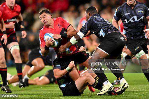 David Havili of the Crusaders is tackled during the round four Super Rugby Pacific match between Crusaders and Hurricanes at Apollo Projects Stadium,...
