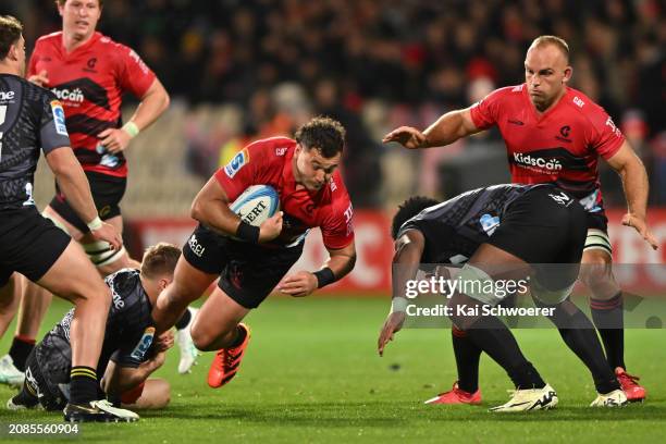 David Havili of the Crusaders is tackled during the round four Super Rugby Pacific match between Crusaders and Hurricanes at Apollo Projects Stadium,...