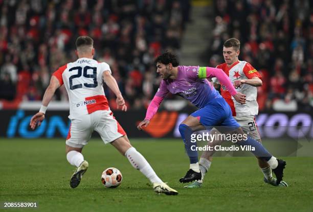 Theo Hernandez of AC Milan competes for the ball with Davis Doudera and Michal Tomic of Slavia Praha during the UEFA Europa League 2023/24 round of...