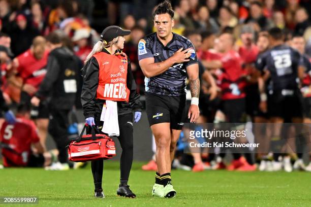Peter Umaga-Jensen of the Hurricanes is helped by a medic during the round four Super Rugby Pacific match between Crusaders and Hurricanes at Apollo...