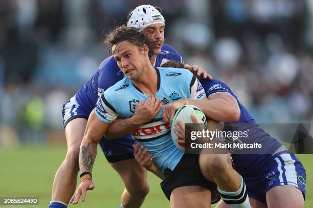 Nicho Hynes of the Sharks is tackled during the round two NRL match between Cronulla Sharks and Canterbury Bulldogs at PointsBet Stadium on March 15...