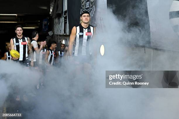 Darcy Moore of the Magpies leads his team out onto the field before the round one AFL match between Collingwood Magpies and Sydney Swans at Melbourne...