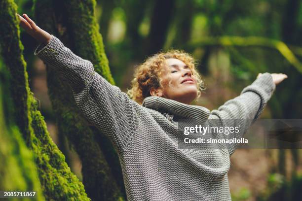 Happiness and nature wellbeing healthy people. One woman smile and enjoy freedom in outdoor leisure activity. Celebrating planet earth. Travel nature destination. Outstretching arms to breathe oxygen