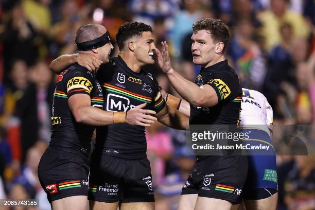 Dylan Edwards of the Panthers celebrates scoring a try with Nathan Cleary and Liam Martin of the Panthers during the round two NRL match between...