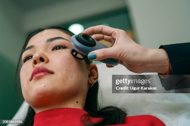 doctor using dermoscope on patients face. - melanoma stock pictures, royalty-free photos & images