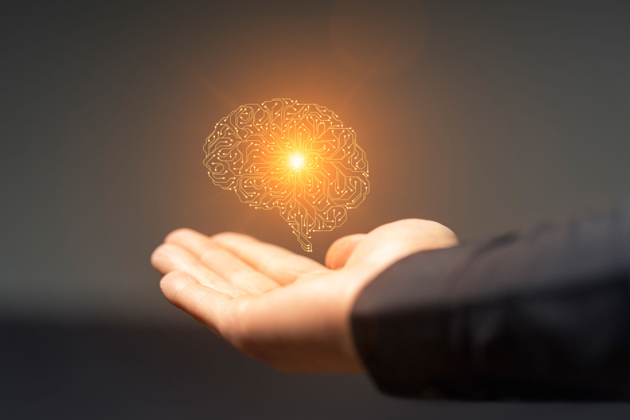 Artificial intelligence circuit board brain symbol on hand Artificial intelligence circuit board brain symbol on hand