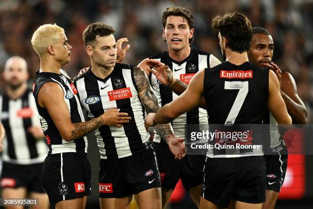 Jamie Elliott of the Magpies celebrates with his team mates after kicking a goal during the round one AFL match between Collingwood Magpies and...
