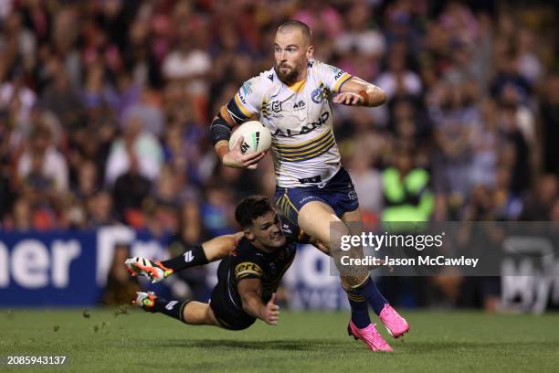 Clint Gutherson of the Eels evades the tackle of Nathan Cleary of the Panthers during the round two NRL match between Penrith Panthers and Parramatta...