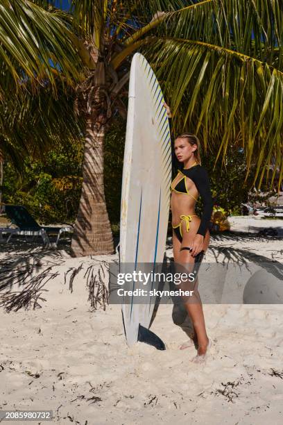 pensive female surfer during summer day on the beach. - meeru island stockfoto's en -beelden