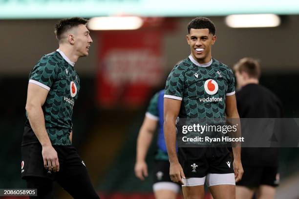 Rio Dyer reacts as he interacts with Josh Adams of Wales during the Wales Captain's Run, prior to the Guinness Six Nations Round Five match between...