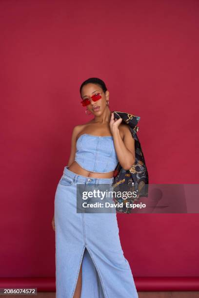 fashionable young woman posing in denim outfit - denim skirt stock pictures, royalty-free photos & images
