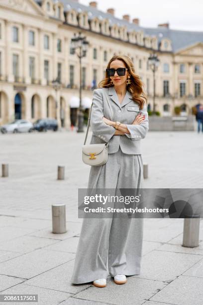 Alexandra Lapp is seen wearing a The Garment Trento Jacket, The Garment Trento Pants, a Celine Besace Clea bag in grey, For Art’s Sake sunglasses in...