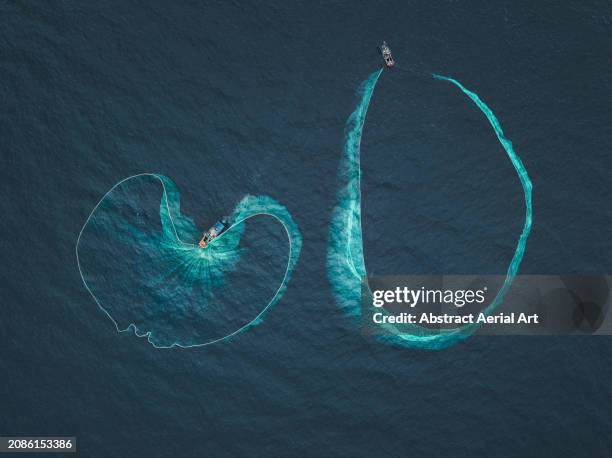 two fishing trawlers catching anchovies photographed from a drone perspective, vietnam - side by side comparison stock pictures, royalty-free photos & images