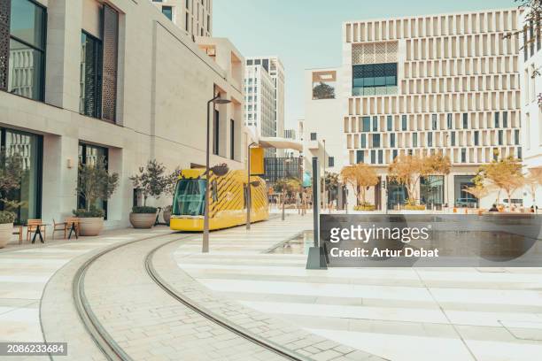 the modern district of msheireb with tram in the downtown of doha. - qatar business stock pictures, royalty-free photos & images