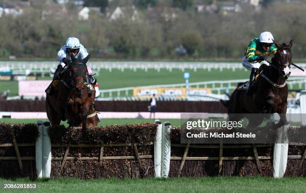 Majborough ridden by Mark Walsh jumps the last ahead of Kargese ridden by Danny Mullins on their way to winning the JCB Triumph Hurdle during day...