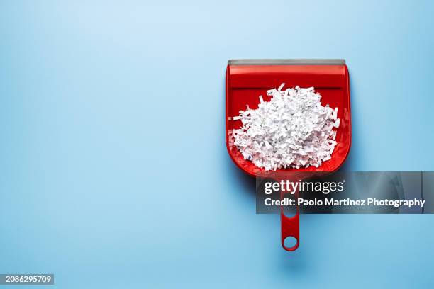 shredded paper on plastic dustpan - sweeping stock pictures, royalty-free photos & images