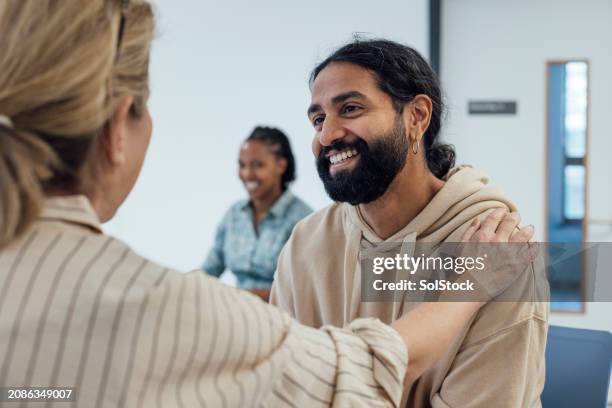 feeling happier with help - hand on shoulder stock pictures, royalty-free photos & images