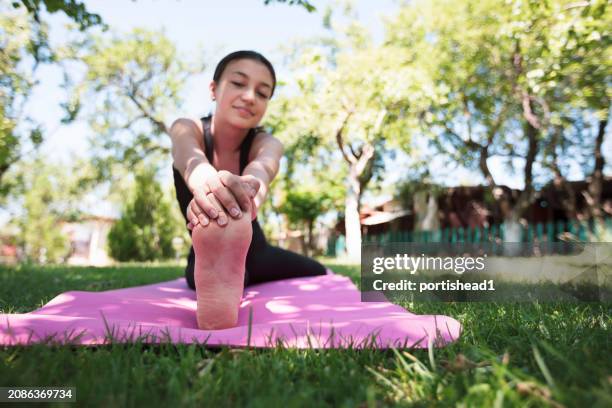 тeenage girl doing yoga and stretching in backyard - beautiful girls legs stock pictures, royalty-free photos & images