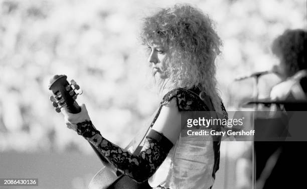 American Rock musician Nancy Wilson, of the group Heart, plays an Ovation guitar as she performs onstage, during the 'Bebe Le Strange' tour, at...