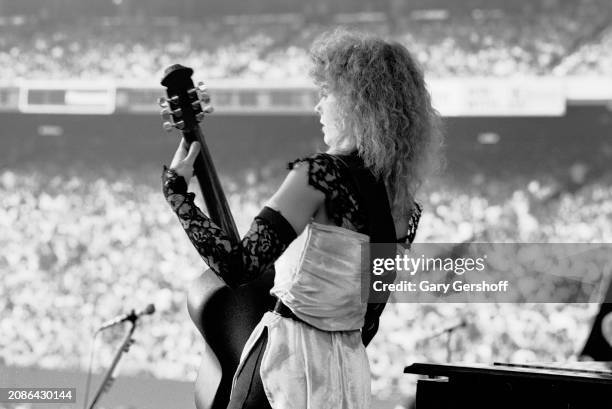 American Rock musician Nancy Wilson, of the group Heart, plays an Ovation guitar as she performs onstage, during the 'Bebe Le Strange' tour, at...