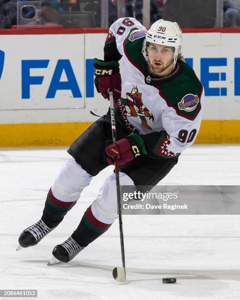 Moser of the Arizona Coyotes skates up ice with the puck against the Detroit Red Wings during the first period at Little Caesars Arena on March 14,...