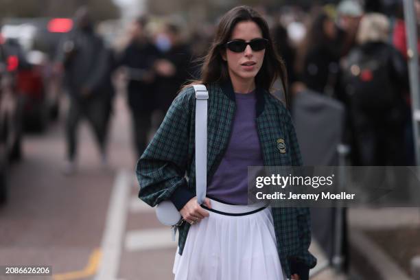 Nina Urgell Cloquell seen wearing a white tennis skirt, green and black checkered Lacoste jacket, purple shirt, black shades, black leather loafer,...