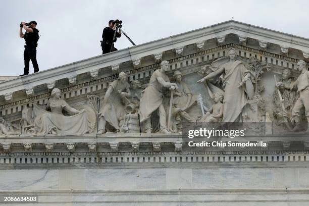 Members of the U.S. Secret Service Counter-Sniper team set up watch from the roof of the House of Representatives as President Joe Biden arrives at...