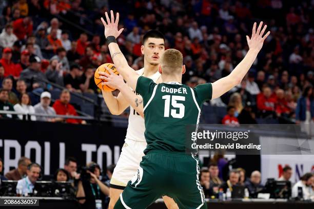 Zach Edey of the Purdue Boilermakers looks to pass against Carson Cooper of the Michigan State Spartans in the first half at Target Center in the...