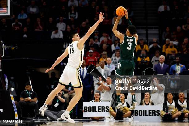 Jaden Akins of the Michigan State Spartans shoots the ball against Zach Edey of the Purdue Boilermakers in the first half at Target Center in the...