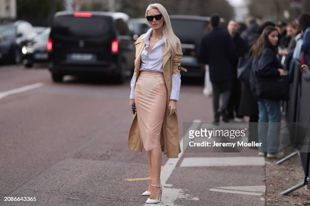 Kate Davidson Hudson seen wearing a rose long skirt, white blouse, beige trench coat, white heels and black shades outside Lacoste Show during the...