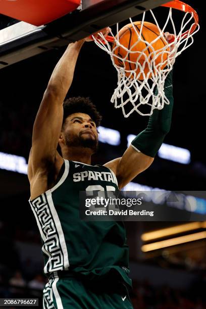 Malik Hall of the Michigan State Spartans dunks the ball against the Purdue Boilermakers in the second half at Target Center in the Quarterfinals of...