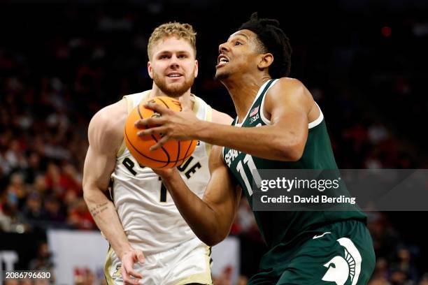 Hoggard of the Michigan State Spartans drives to the basket against Caleb Furst of the Purdue Boilermakers in the second half at Target Center in the...