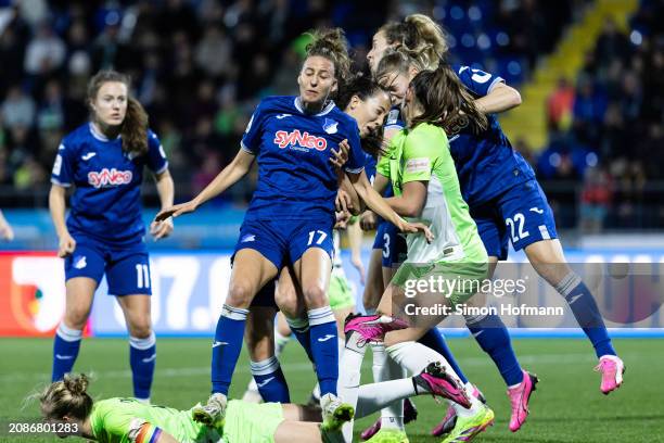 Sarai Linder of Hoffenheim is challenged by Sveindis Jonsdottir of Wolfsburg during the Google Pixel Women's Bundesliga match between TSG Hoffenheim...