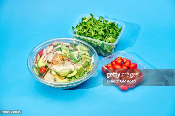various salad bowls in plastic container on blue background - polypropylene stock pictures, royalty-free photos & images