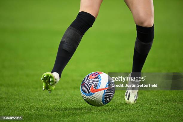 An Arsenal player warms up with a black pair of socks after being forced to change colour socks which results in a delayed kick off time prior to the...