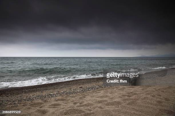 beach and mediterranean sea with overcast sky - mediterranean climate stock pictures, royalty-free photos & images