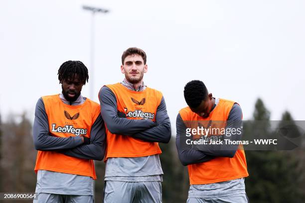 Boubacar Traore, Santiago Bueno and Nelson Semedo of Wolverhampton Wanderers pose for a photo following a Wolverhampton Wanderers Training Session at...