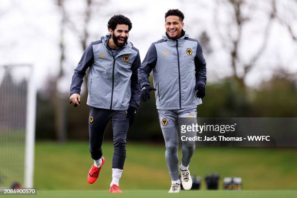 Rayan Ait-Nouri and Joao Gomes of Wolverhampton Wanderers walk out ahead of a Wolverhampton Wanderers Training Session at The Sir Jack Hayward...