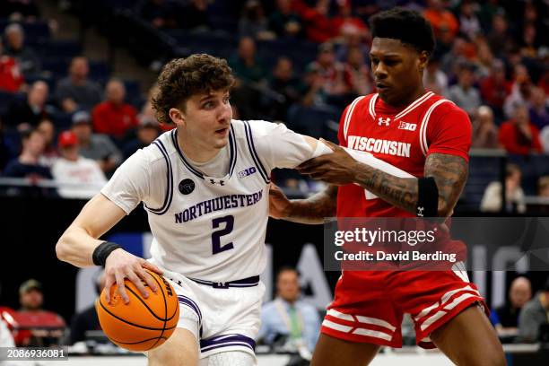 Nick Martinelli of the Northwestern Wildcats drives to the basket against AJ Storr of the Wisconsin Badgers in the first half at Target Center in the...