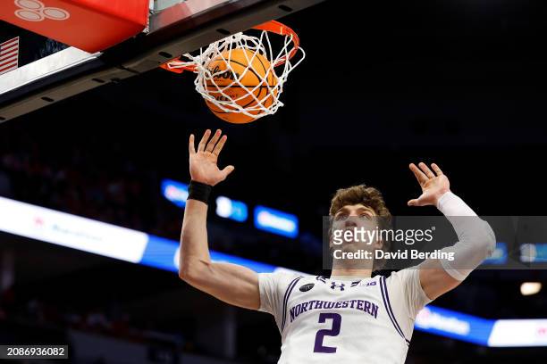 Nick Martinelli of the Northwestern Wildcats dunks the ball against the Wisconsin Badgers in the first half at Target Center in the Quarterfinals of...