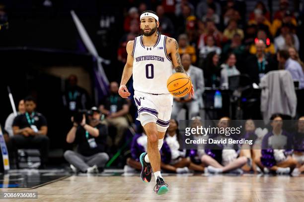 Boo Buie of the Northwestern Wildcats dribbles the ball against the Wisconsin Badgers in the first half at Target Center in the Quarterfinals of the...