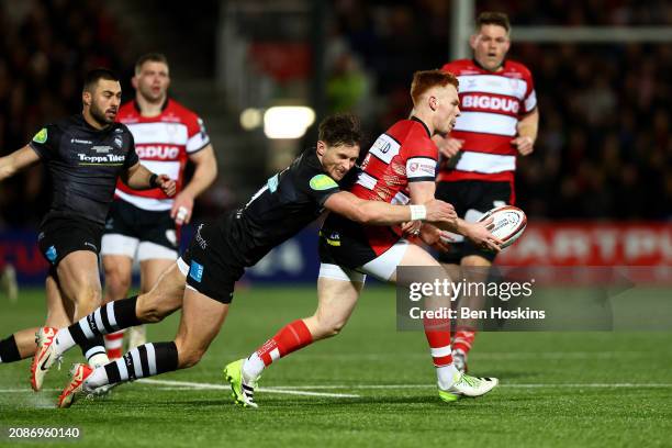 Caolan Englefield of Gloucester is tackled by Josh Bassett of Leicester during the final of the Premiership Rugby Cup between Gloucester Rugby and...