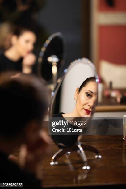 young dancer/actress putting on makeup backstage to perform - 101cats stock pictures, royalty-free photos & images