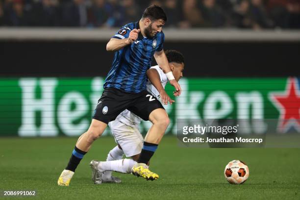 Sead Kolasinac of Atalanta dispossesses Marcus Edwards of Sporting CP during the UEFA Europa League 2023/24 round of 16 second leg match between...