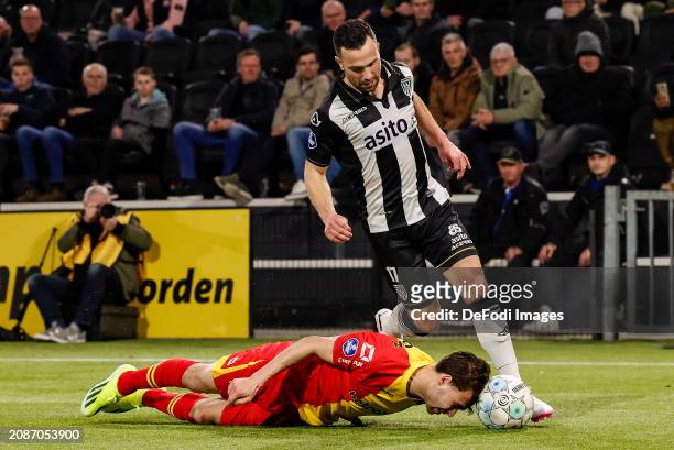 Enric Llansana of Go Ahead Eagles and Thomas Bruns of Heracles Almelo battle for the ball during the Dutch Eredivisie match between Heracles Almelo...
