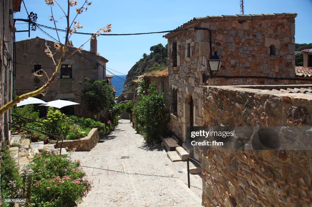 Typical street in Tossa de Mar old town (Catalonia, Spain)
