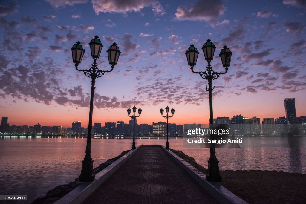 Public lantern lights and Abu Dhabi Skyline at sunrise