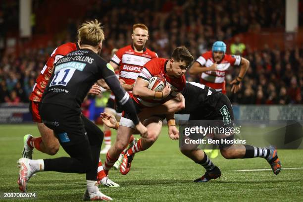 Charlie Atkinson of Gloucester makes a break for the try line as he scores his team's first try of the game during the final of the Premiership Rugby...